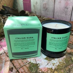 Boy smells Italian kush candle with box